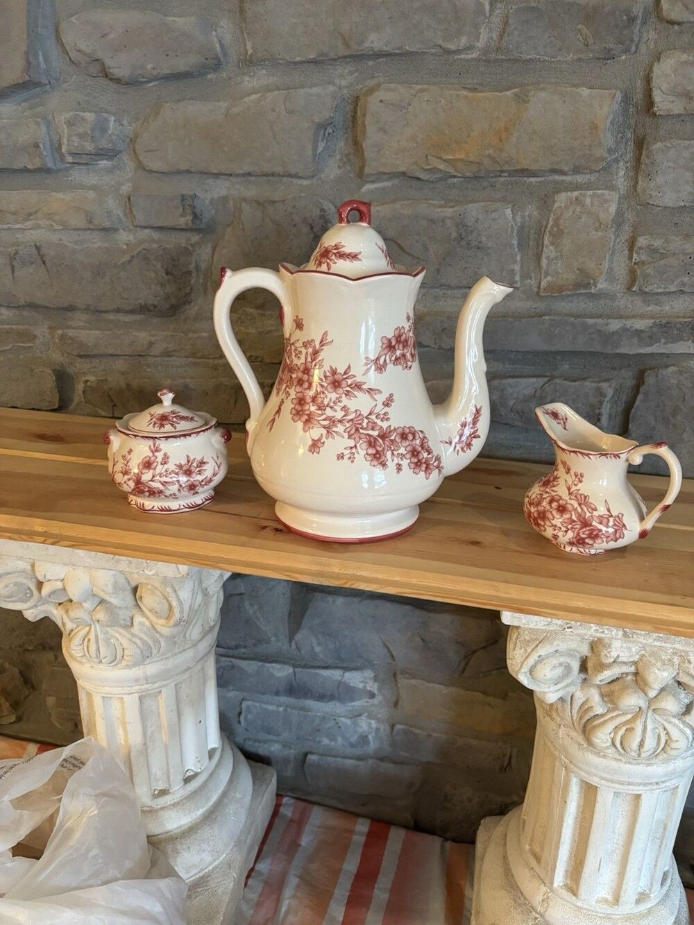 Tea set from Cracker Barrel featuring a red/cream floral transferware pattern.